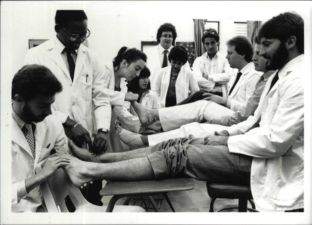 Podiatry students demonstrating foot screening examination to classmates